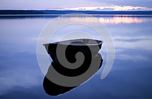 Blue quiet. Boat with reflection.