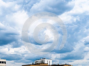 Blue rainy clouds over urban houses on spring