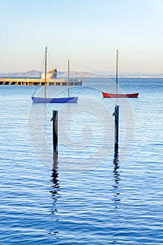 Blue and red boats near the pier at Fisherman`s Wharf in San Francisco, CA