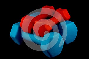 Blue and Red Dumbells on a Black Background