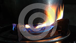 blue red fire from domestic kitchen stovetop. Gas cooker with burning flames of propane gas. Gas burner on the stove. concept of