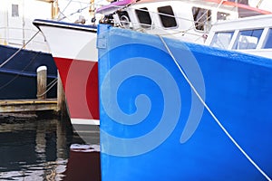 Blue and red fishing vessels on Lewis Bay in Hyannis Massachusetts