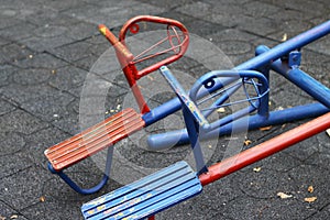 Blue and red horse shaped seesaws