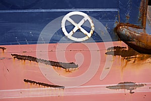 Blue and red hull of freighter seen up close gives abstract pattern