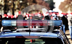 blue and red sirens of the police car in the public park with m