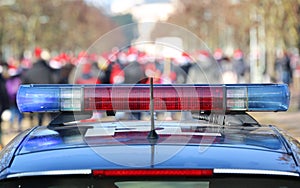 blue and red sirens on the police car in the public urban park