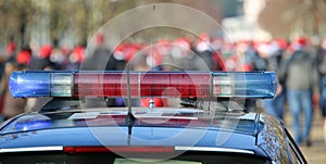 blue and red sirens on the police car in the public urban park