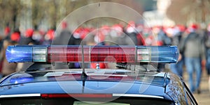 blue and red sirens on the police car in the public urban park photo