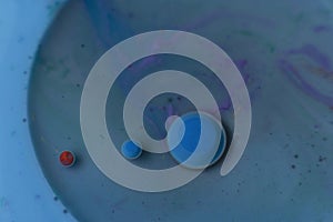 Blue and red spheres on turquoise blue background with circles