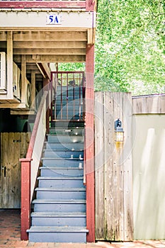 Blue and Red Staircase Outdoors Tucked in a Little Street