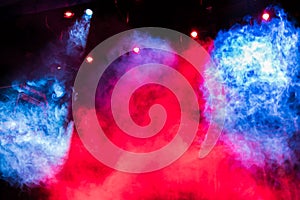 Blue and red theatrical smoke on stage. Lighting equipment. Theatrical performance or show