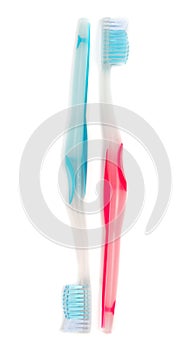 A blue and a red toothbrush isolated on white background.