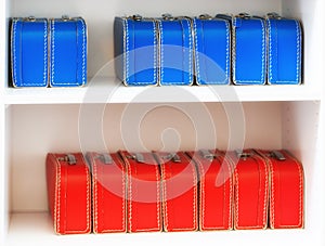 Blue and red toy cases on the shelf background