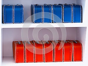 Blue and red toy cases on the shelf background