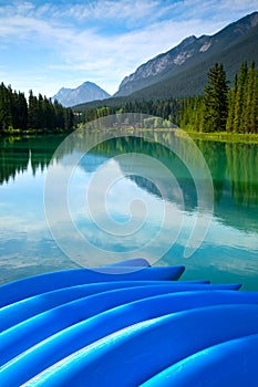 Blue rental canoes along the Bow River in Banff National Park