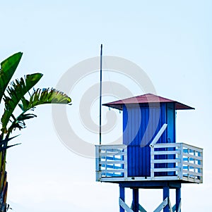 Blue rescue hut on a sandy beach, safe relax by the ocean, a beautiful sunny day