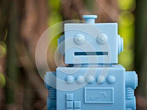 Blue Retro robot toys on Natural green leaves background