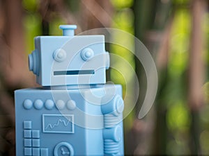 Blue Retro robot toys on Natural green leaves background