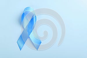Blue ribbon on blue background, prostate cancer awareness concept.