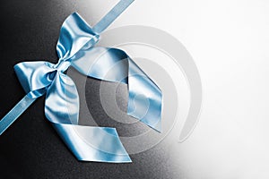 Blue ribbon bow on metal