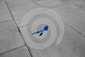 Blue ribbon on gray stone, prostate cancer