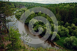 The blue ribbon of the river from the height of the mountains. Wild nature, taiga. Tourism. Far East, Sakhalin Island, Russia.