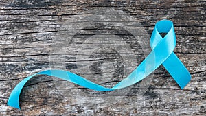 Blue ribbon symbolic of prostate cancer awareness campaign and men`s health in November month photo