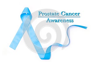 Blue ribbon symbolic for prostate cancer awareness campaign and men`s health in November month isolated on white background