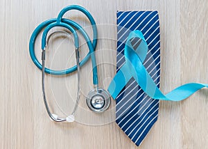 Blue ribbon symbolic of prostate cancer awareness and men`s health in November month  on necktie and stethoscope