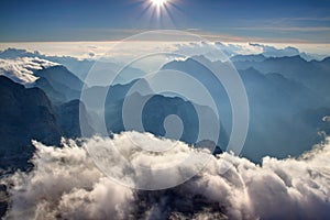 Blue ridges of Julian Alps and hazy Trenta valley from Triglav