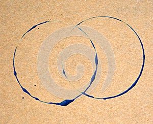 Blue ring stains on brown paper texture background.