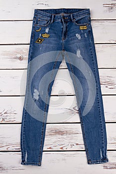 Blue ripped jeans with patches