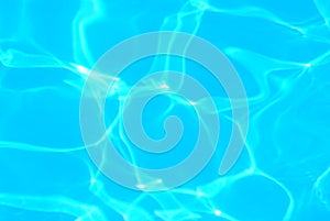 Blue ripped water in swimming pool . texture pool . Shining blue water ripple background