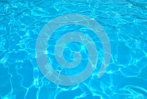 Blue ripped water in swimming pool . texture pool . Shining blue water ripple background