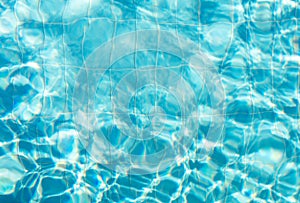 Blue ripped water with waves and rays in the swimming pool Summer vacation Background. Top view Copy space.