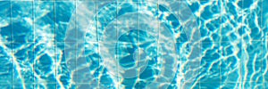 Blue ripped water with waves and rays in the swimming pool Summer vacation Background. Top view Copy space. banner