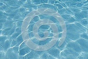 Blue rippled water in swimming pool background