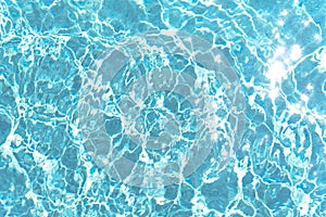 Blue rippled water in swimming pool on sunny summer day