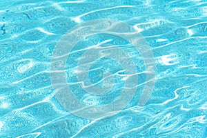 Blue rippled water in swimming pool on sunny summer day