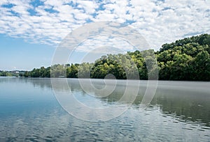 Blue river reflecting sky and trees