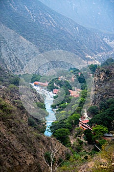 Blue river in Tolantongo, Mexico. Majestic mountains, lush plants, serene waters