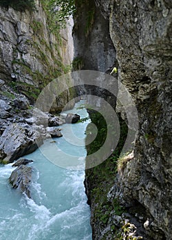 Blue river water cascading between tall canyon walls