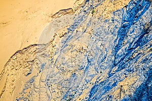 Blue rivulets on sand