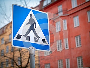 Blue road crossing street sign