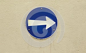 Blue road sign, go to the right. Old blue metallic arrow sign. Traffic sign direction of travel.