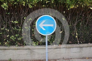 Blue road sign: obligation to turn left