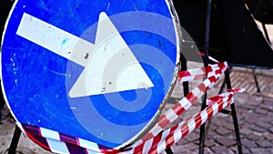 Blue road sign with white arrow Turn Right on metal support