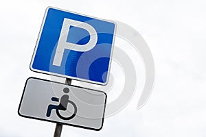 Blue roadsign Disabled bay against white sky