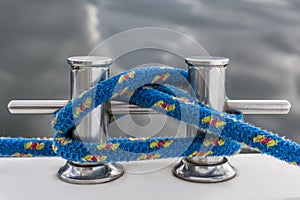 Blue rope fasten on stake of yacht