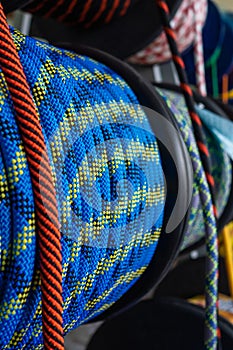 Blue rope on a show-window of shop. A safety rope for climbers. The rope is reeled up on the coil